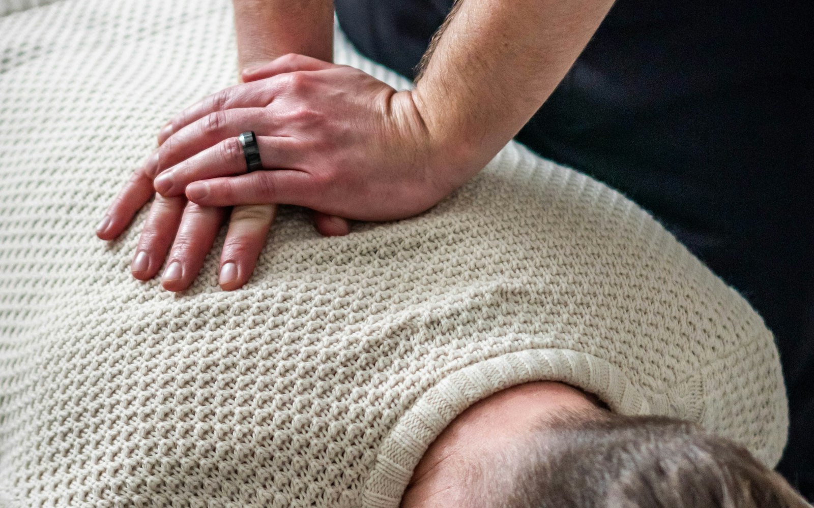 A chiropractor adjusting a patient's upper back and neck